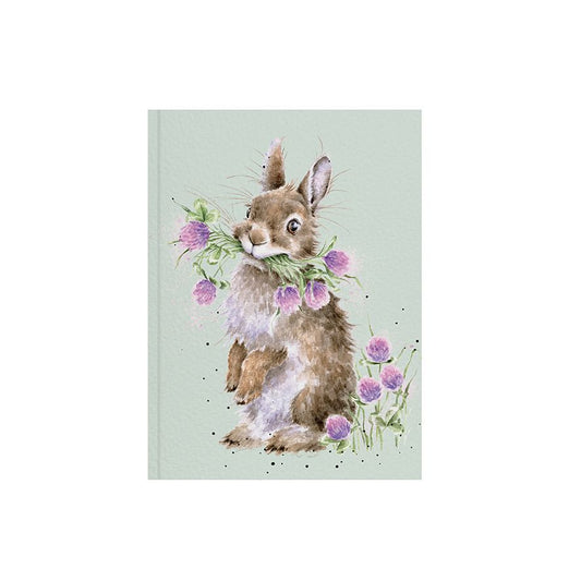 upright rabbit with bunch of purple clover flowers  in mouth